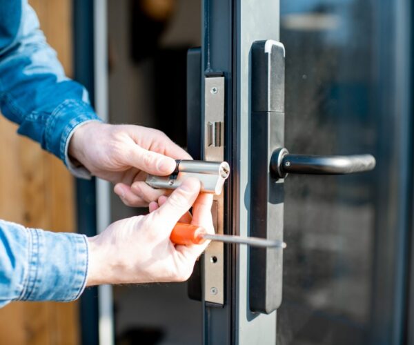 Man changing core of a door lock